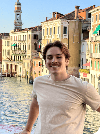 Standing on the side of Rialto Bridge in Italy